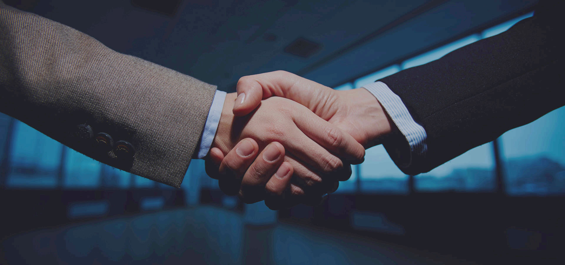 Two men shaking hands after a deal is made.